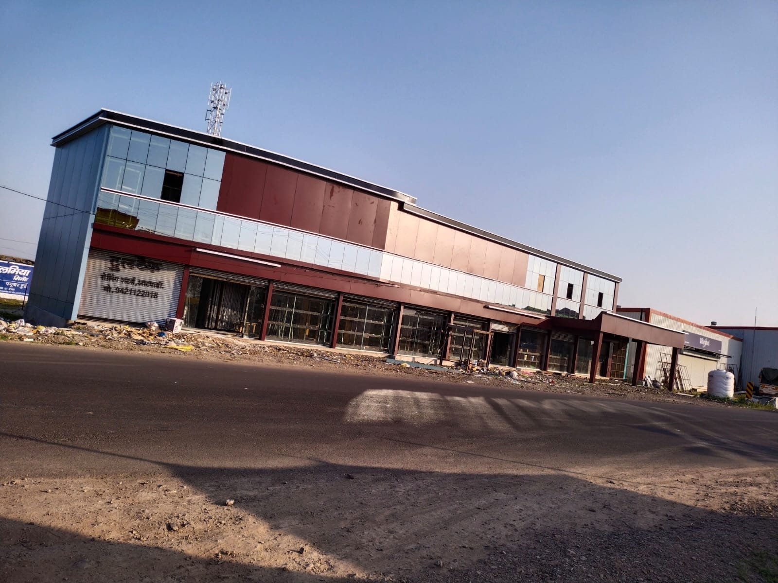 Completed commercial building with ACP cladding and glass shopfronts
